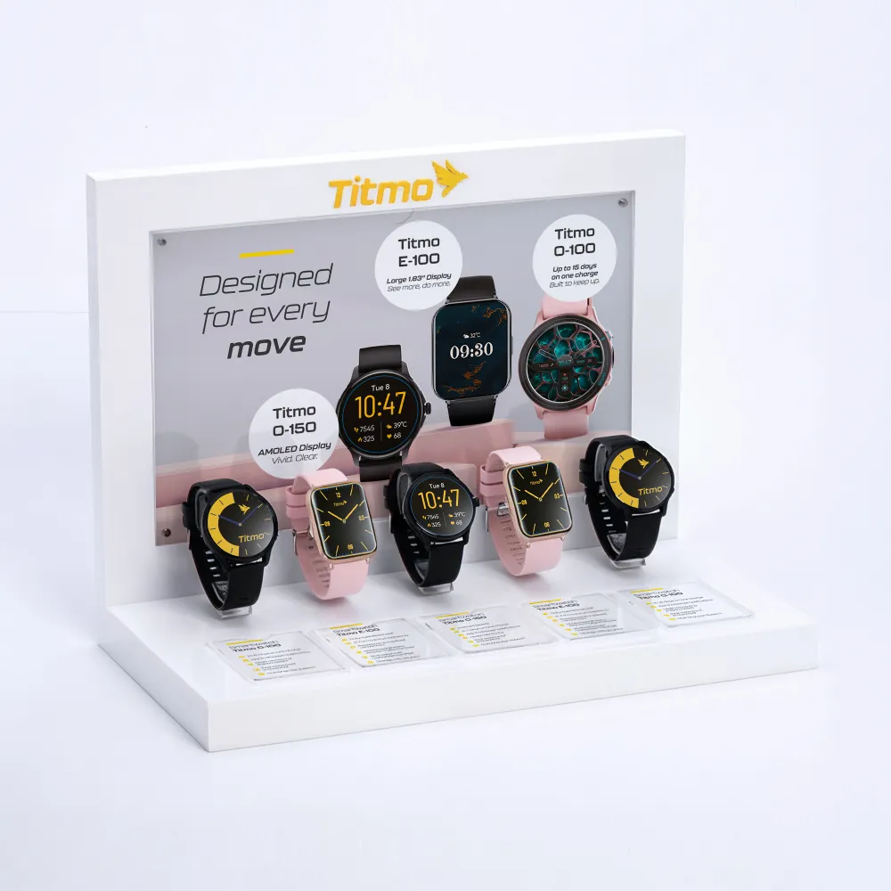 Stand ekspozycyjny Titmo prezentujący różne modele smartwatchy na białej podstawie z opisami funkcji i hasłem Designed for every move
